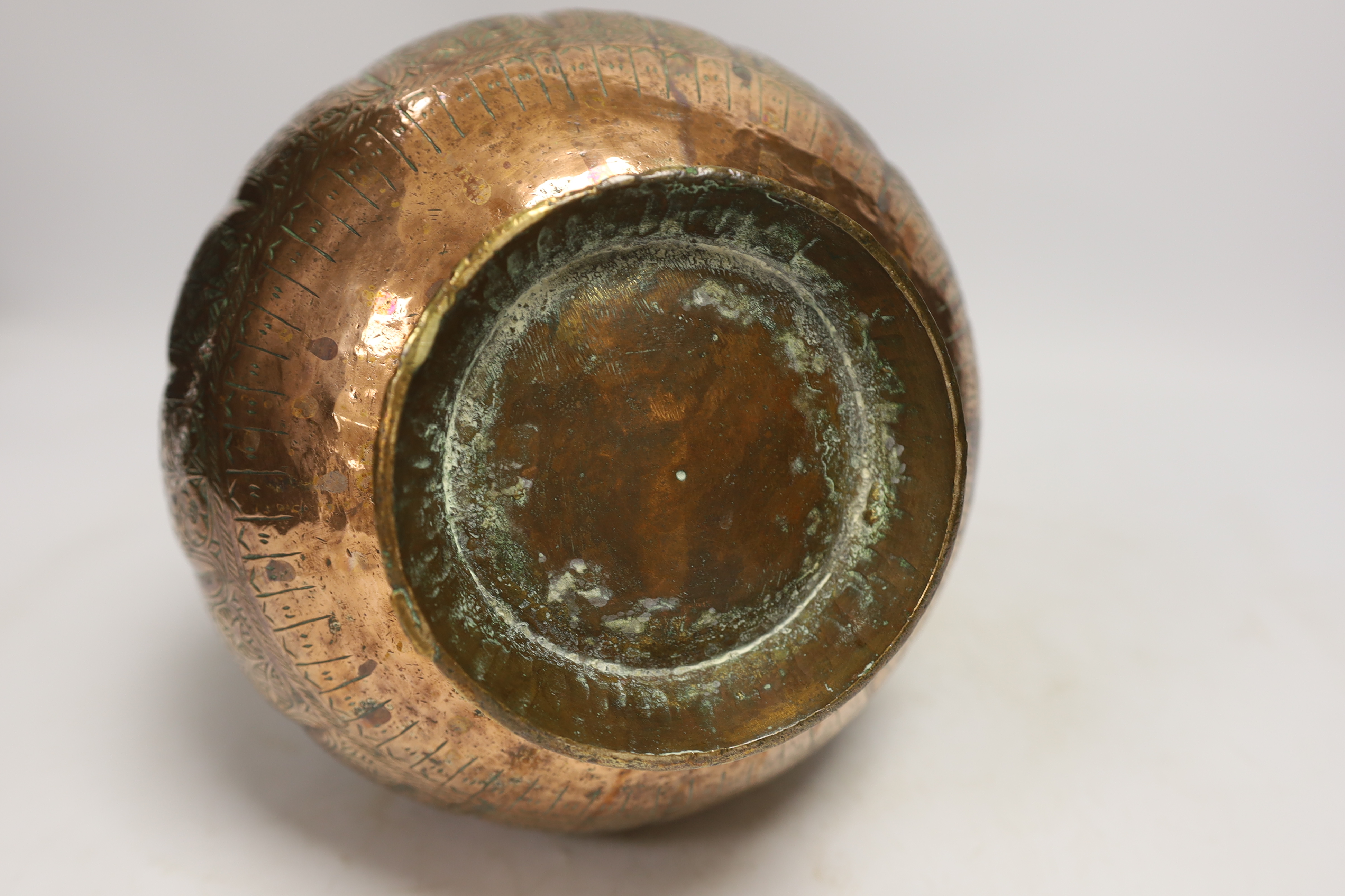 An Islamic engraved copper vase, 31cm